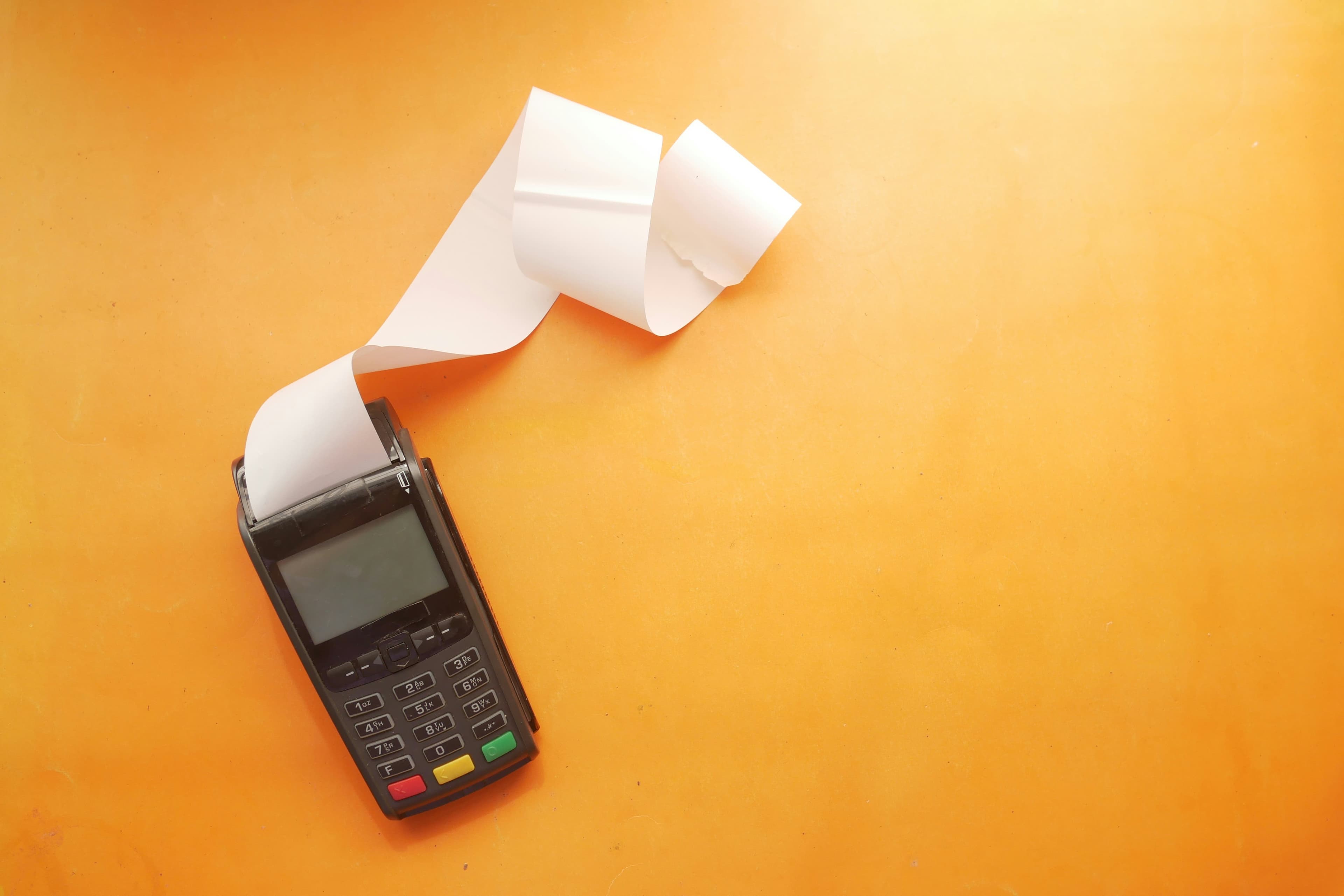 A card terminal printing a paper receipt